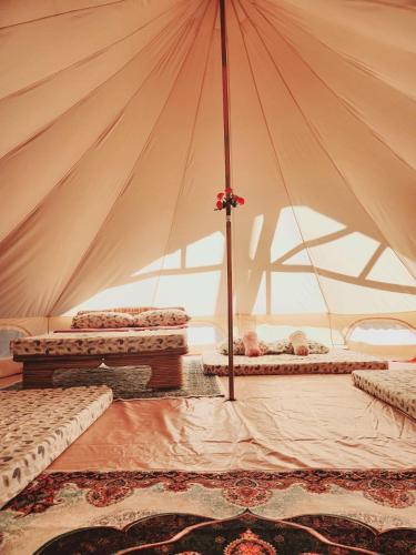 a tent with three beds in a room at Kubo ni Apple in Tagbina