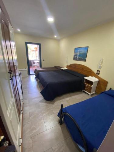 a bedroom with two beds and a television in it at Hotel Federico II in Naples