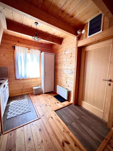 an empty room with a door in a wooden house at Starry Sky Zlatibor in Krajevi