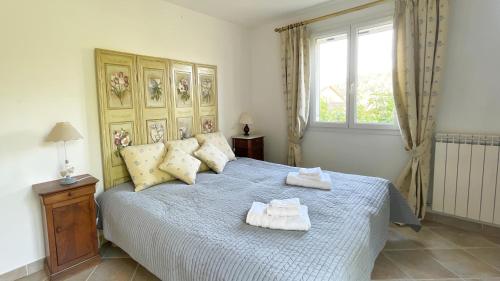une chambre avec un grand lit avec des serviettes dessus dans l'établissement Villa Les Cistes, à La Colle-sur-Loup