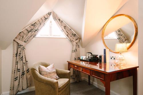 a dressing room with a desk and a mirror at Ansty Hall in Coventry