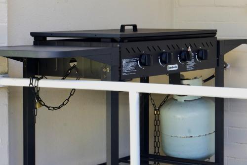 a table with a gas stove on top at Ella's Beach Haven in Batehaven