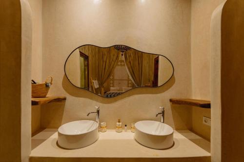 a bathroom with two sinks and a mirror on the wall at Riad Senja in Marrakech