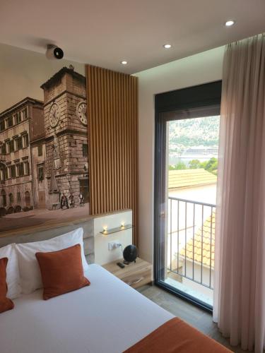 a bedroom with a bed and a large window at Marea DeLuxe Apartments in Kotor