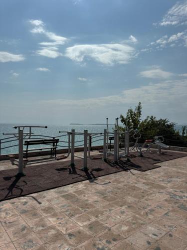a park with benches and a view of the ocean at Fort Noks Panorama in Elenite