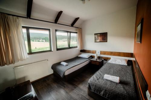 a room with two beds and two windows at Smida Park Mountain Retreat & SPA in Smida