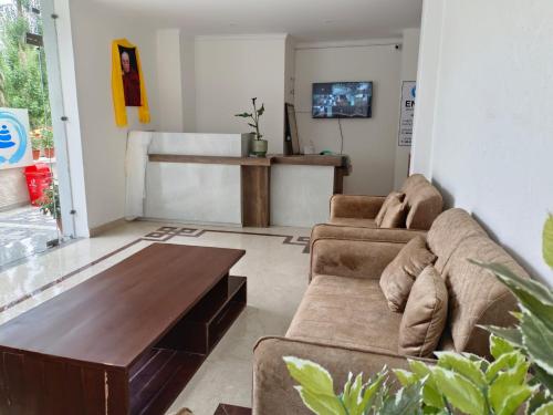 a living room with two couches and a coffee table at Enso Boutique Stay in Leh