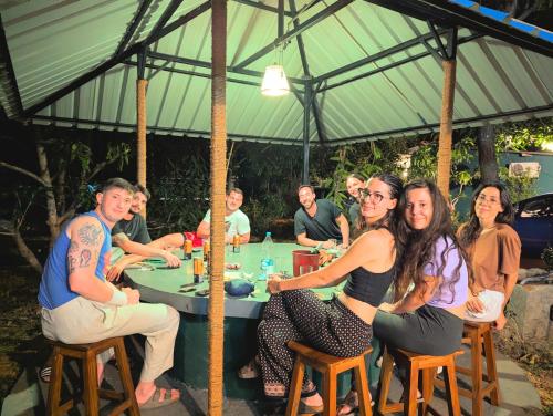 a group of people sitting at a table at Sigiri Choona Lodge 'unique sunrise viewpoint' in Sigiriya