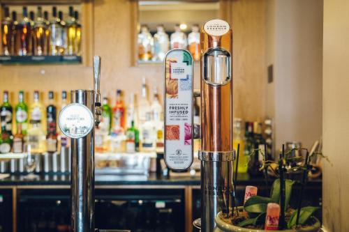 a bar with a counter with signs on it at The Manor Boutique Hotel Restaurant and Bar in Conwy