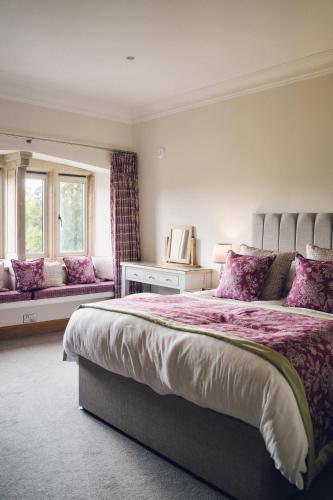 a bedroom with a large bed and a window at The Manor Boutique Hotel Restaurant and Bar in Conwy