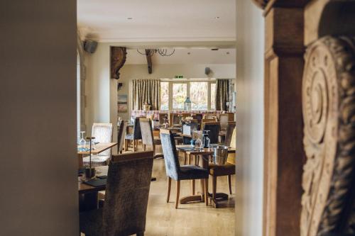 a dining room with tables and chairs at The Manor Boutique Hotel Restaurant and Bar in Conwy