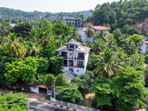 an aerial view of a house in the midst of trees at Seashore Mirissa in Mirissa