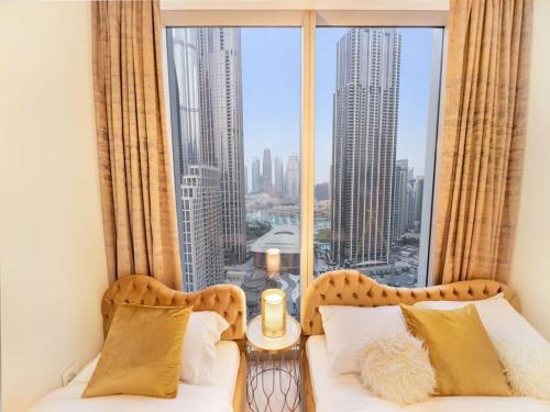 a bedroom with a bed and a large window at Panoramic Full Fountain,Opera& burj Sky View 4BR APT in Dubai