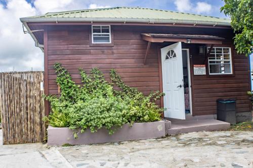 a small house with a white door and a fence at Montete Hilltop Cottage with Stunning Panoramic Views in Jalousie
