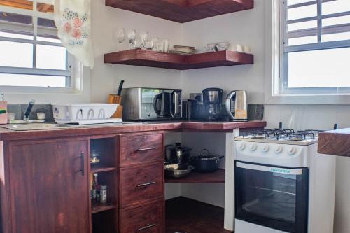 a kitchen with a stove and a stove top oven at Montete Hilltop Cottage with Stunning Panoramic Views in Jalousie
