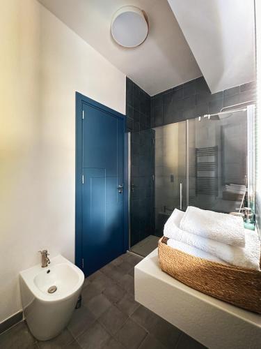 a bathroom with a blue door and a sink at Dimora Harmonia in Carini