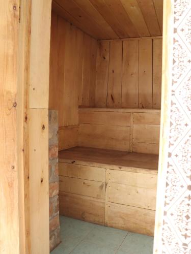 an empty sauna with wooden walls and wooden shelves at Առանձնատուն Սուրբ Հովհաննեսի և Թռչկանի տարածքում in Tsaghkaber
