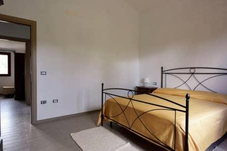 a bedroom with a bed and a mirror at Armandiola in Cardedu