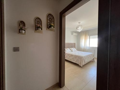 a bedroom with a bed and a window at Outstanding Flat with pool and near the beach in Sahline