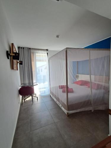 Postel nebo postele na pokoji v ubytování Marina Hôtel Ambatoloaka