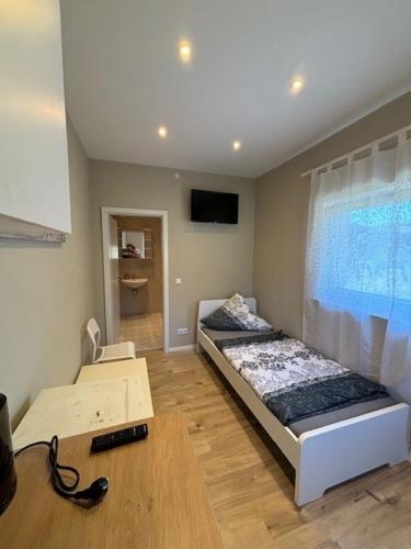 a living room with two beds and a television at Sala Monteur Apartment in Rodenbach