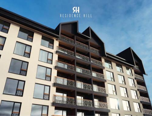 an apartment building with a black roof at Marrilux apartments Residence Hill in Kopaonik