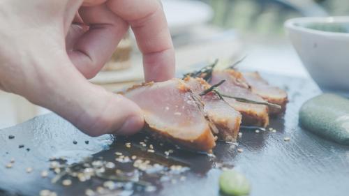a person holding a piece of food on a table at Aldea Rural y Gastro Restaurante Casona de Labrada in Labrada