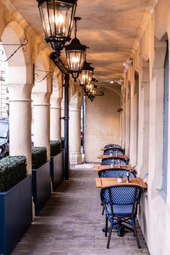a row of tables in a hallway with lights at The Stroud Hotel in Stroud