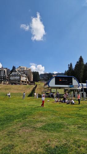 a group of people in a field flying a kite at Marrilux apartments Residence Hill in Kopaonik