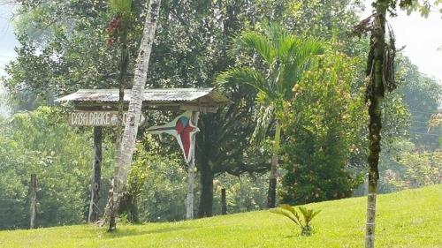 a cross and a street sign in a field at Casa Drake Lodge in Drake