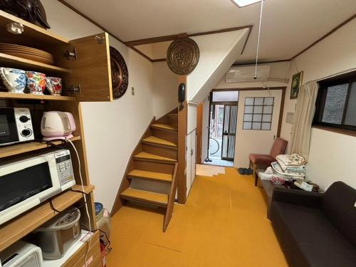 a room with a staircase in a tiny house at AnNam Stay Osaka Airport - whole two story house rental in Toyonaka