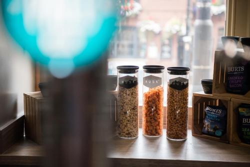 four containers of seeds sitting on a table at The Townhouse Manchester in Manchester