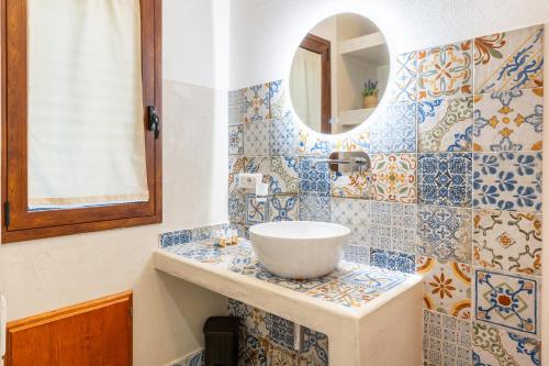 a bathroom with a sink and a mirror at Armandiola in Cardedu