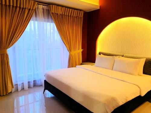 a bedroom with a bed and a large window at Regal Suite by StayMehman in Rawalpindi