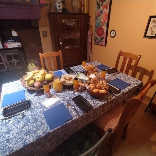 a table with a bunch of food on it at Chez Anne et Christian in Saint-Bertrand-de-Comminges