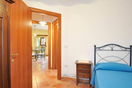 a bedroom with a bed and a dining room at Armandiola in Cardedu