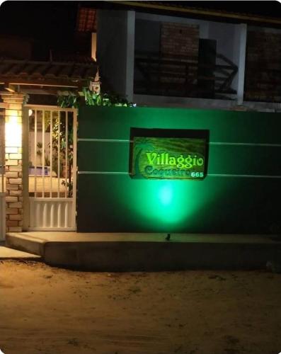 a green sign on the side of a building at Villagio Coqueiro in Luis Correia