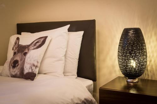 a bed with a picture of a deer on the pillow at Lamlash Bay Hotel in Lamlash