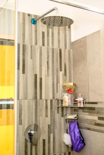 a bathroom with a shower with a shower curtain at Carolina Resort in Carolina
