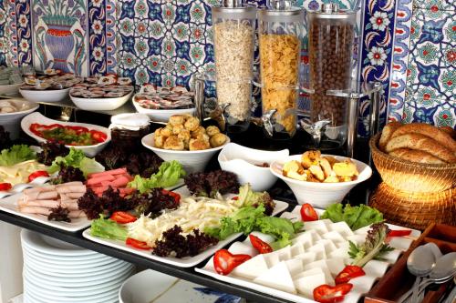 a buffet filled with different types of food on plates at Aldem Hotel in Istanbul
