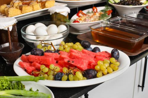 a table topped with plates of fruit and vegetables at Aldem Hotel in Istanbul