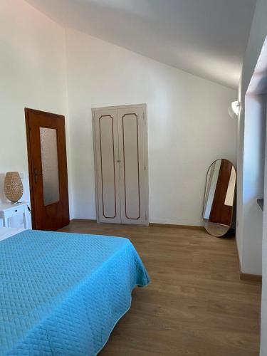 a bedroom with a blue bed and a mirror at Greenlove in Agerola