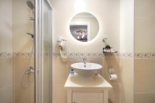 a bathroom with a sink and a shower at Aldem Hotel in Istanbul
