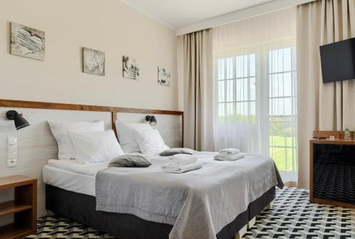 Ένα ή περισσότερα κρεβάτια σε δωμάτιο στο Hotel Półwysep Wądzyn