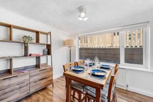 a dining room with a table with chairs and a window at Minutes from the port of Dover, free WiFi, free offroad private parking and rated a guest favourite on Air b nb! in Kent