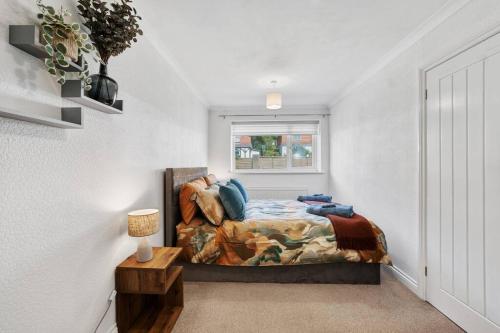 a bedroom with a bed and a window at Minutes from the port of Dover, free WiFi, free offroad private parking and rated a guest favourite on Air b nb! in Kent