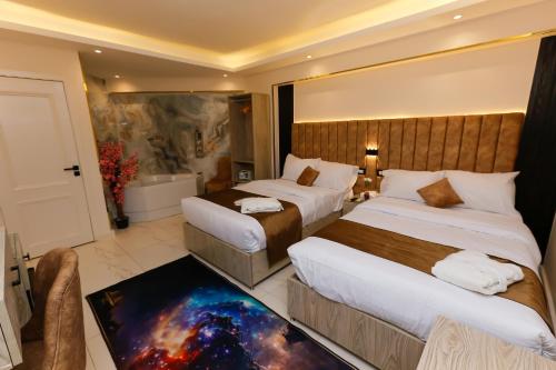 a hotel room with two beds and a bathroom at Horizon Pyramid View INN in Cairo