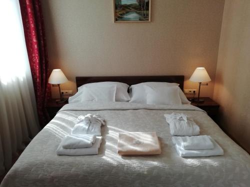 a bedroom with a bed with towels on it at Batthyány Kastélyszálló in Zalacsány