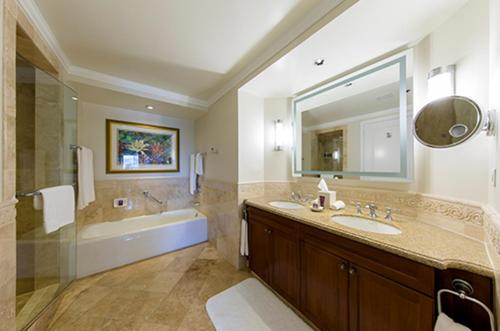 a bathroom with a sink and a tub and a mirror at Ritz Carlton Club - St Thomas in St Thomas