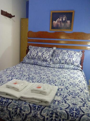 a bedroom with a bed with two towels on it at Dennisse Hotel in Victoria